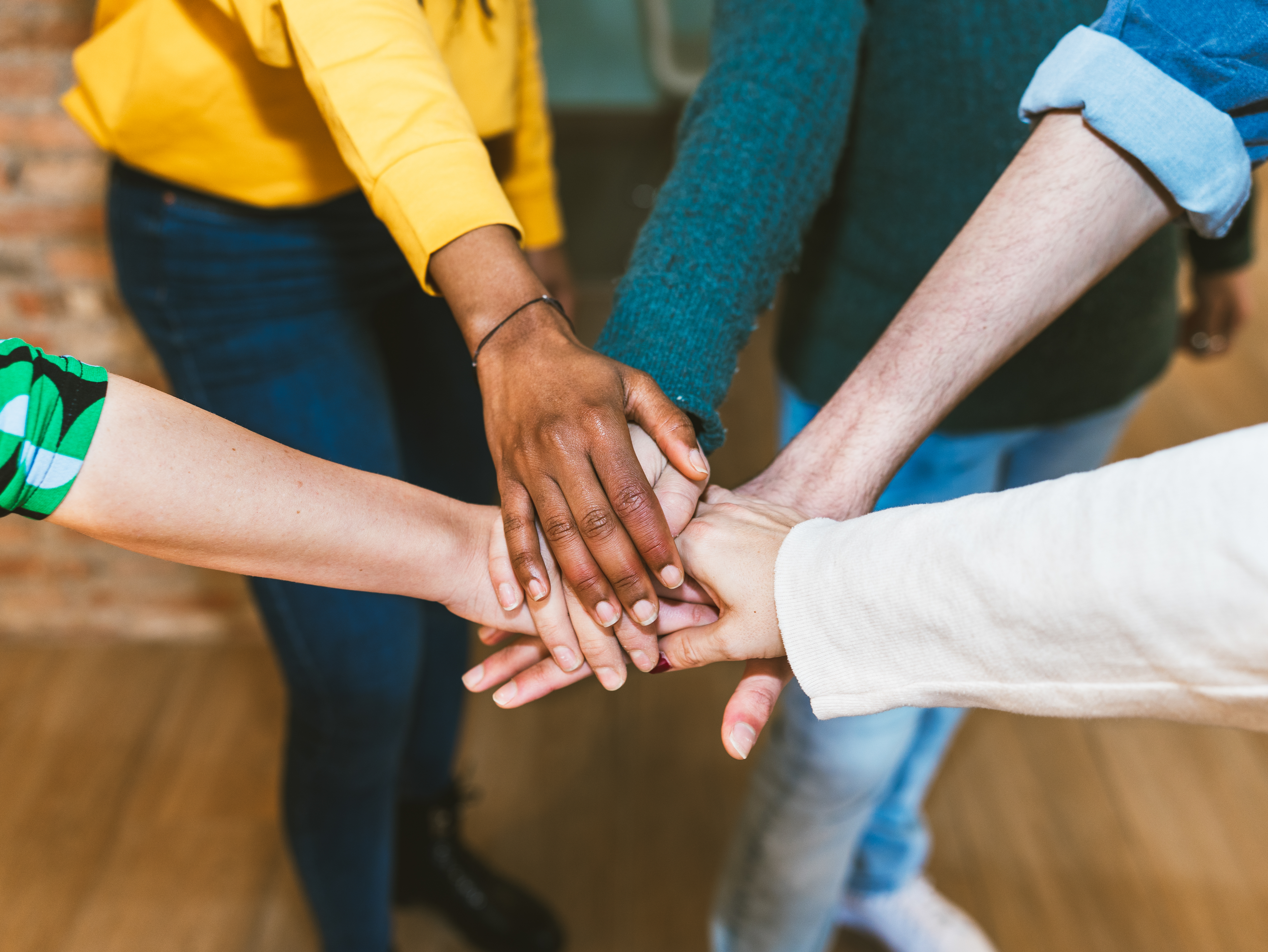 Diverse group of community members collaborating, symbolizing community reintegration and support.