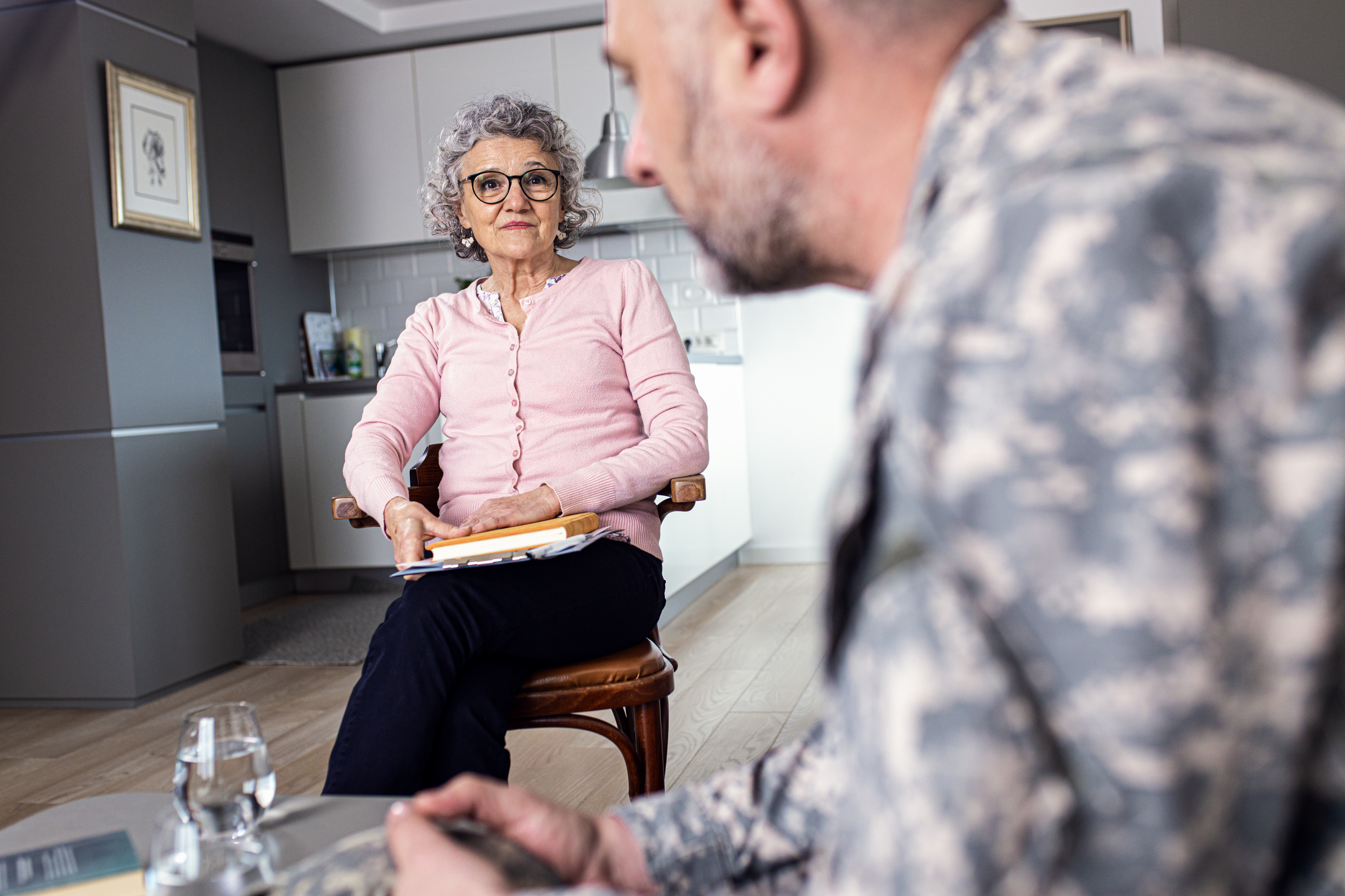 Diverse faces representing veterans, women, seniors, and individuals achieving stability.