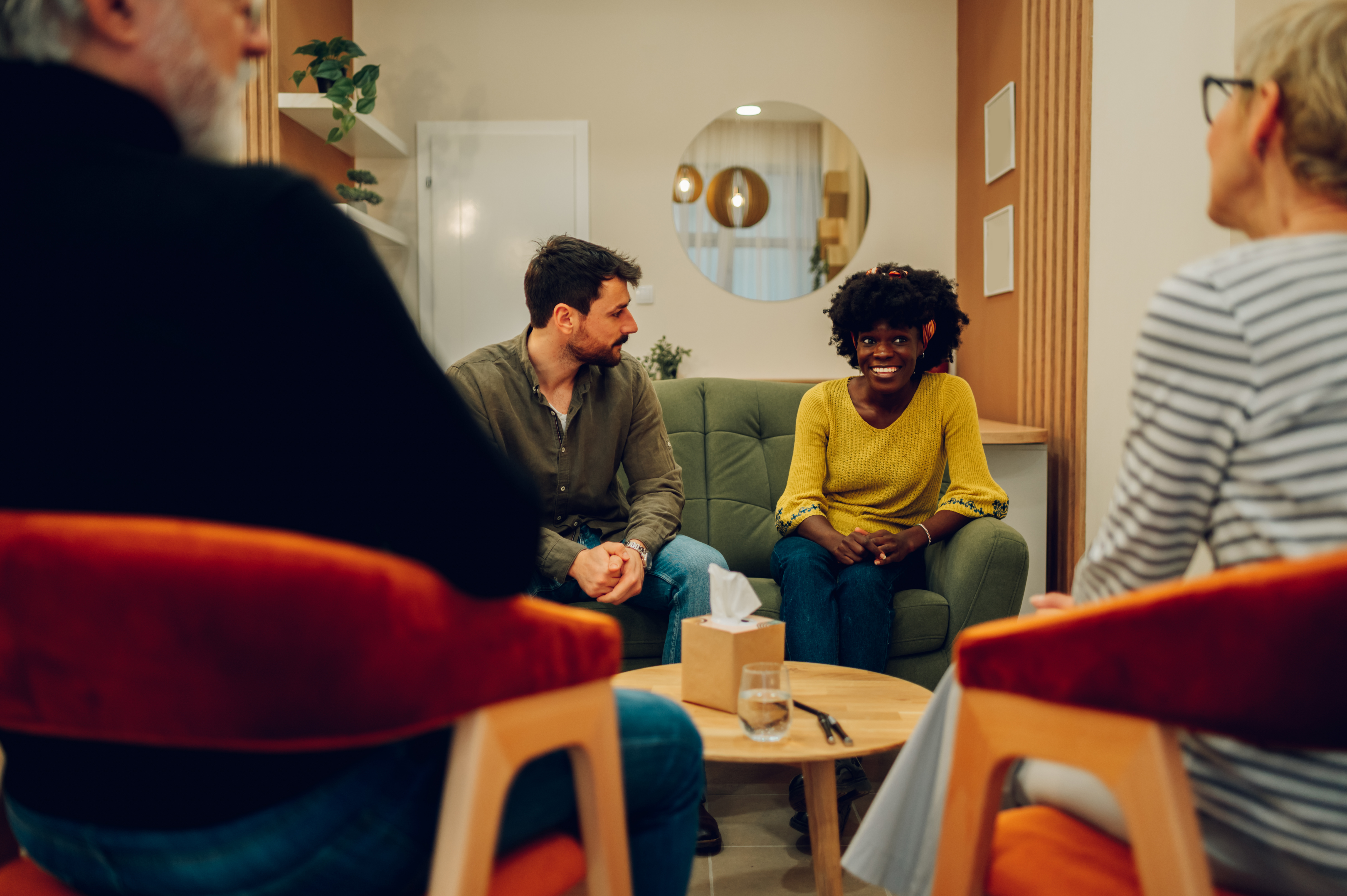 People around a table discussing finances or job training materials.